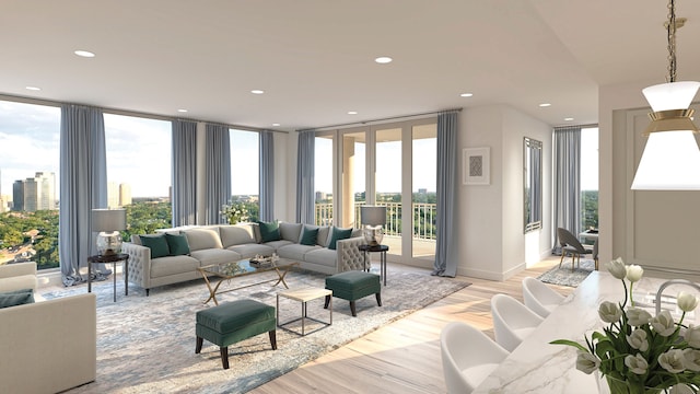 living room with plenty of natural light, floor to ceiling windows, and light hardwood / wood-style floors