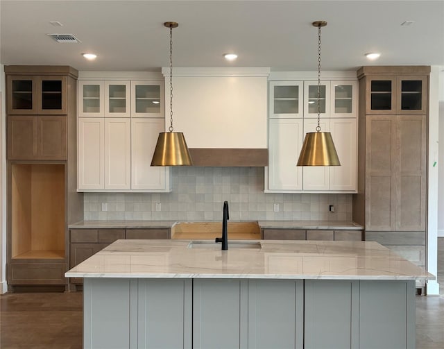 6104 T St, Katy, TX 77493 - kitchen featuring a sink, an island with sink, light stone countertops, decorative light fixtures, and recessed lighting