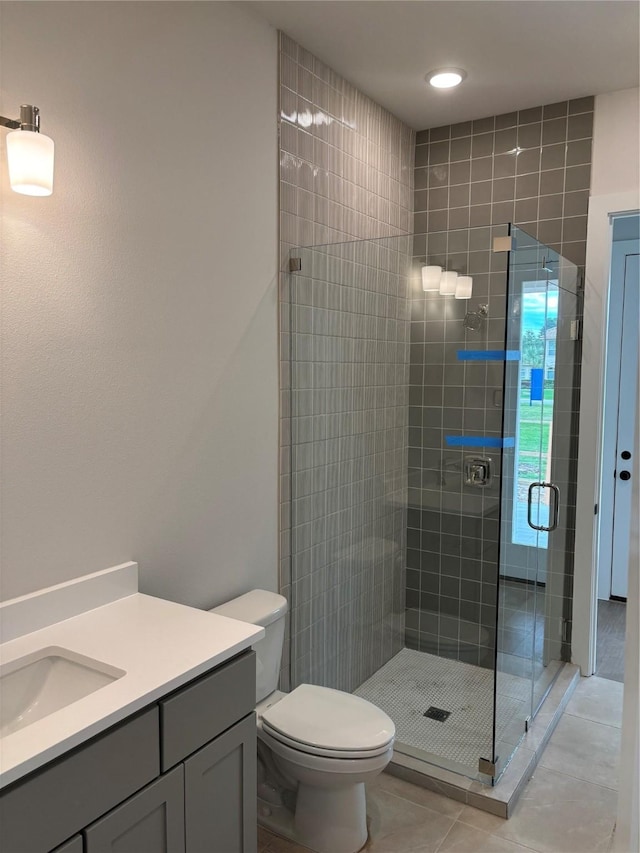 6104 T St, Katy, TX 77493 - bathroom featuring tile patterned floors, a shower stall, vanity, and toilet