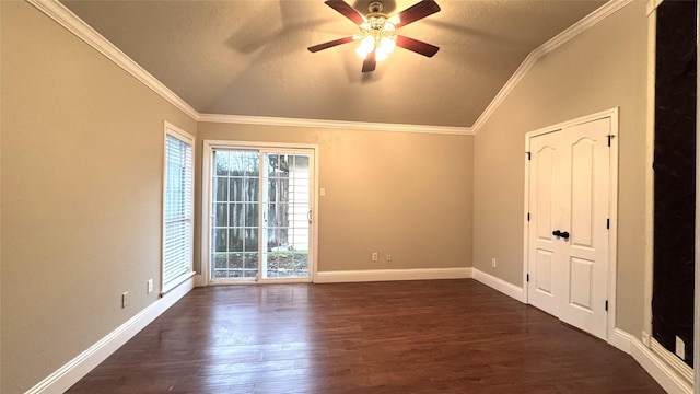 spare room featuring vaulted ceiling, ornamental molding, and dark hardwood / wood-style floors