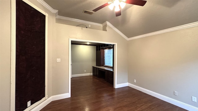 empty room with crown molding, ceiling fan, dark hardwood / wood-style flooring, and vaulted ceiling