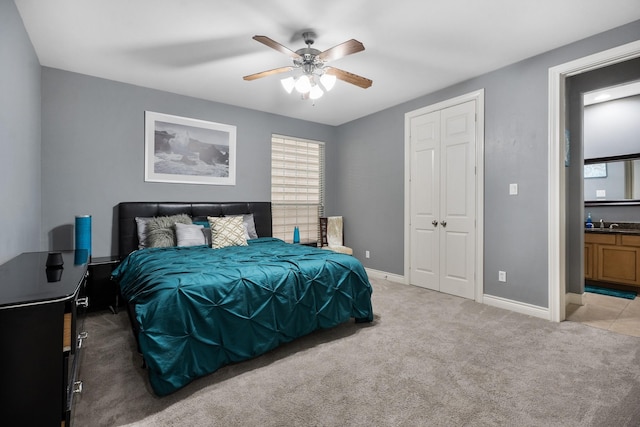 carpeted bedroom with connected bathroom, a closet, and ceiling fan