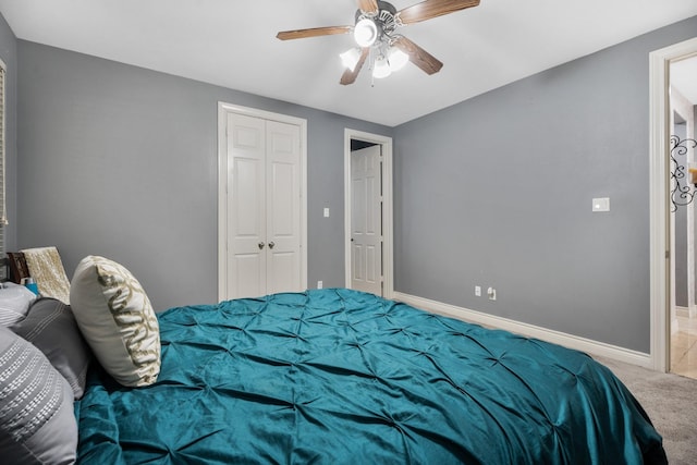 bedroom with ceiling fan, carpet floors, and a closet