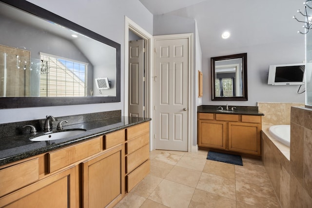 bathroom with tile patterned flooring, vanity, and independent shower and bath