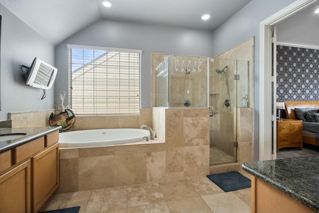 bathroom with independent shower and bath, vanity, lofted ceiling, and tile patterned flooring