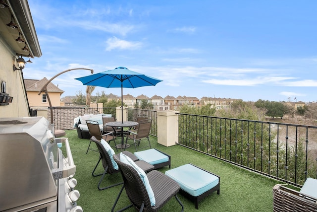 view of patio / terrace featuring a grill and a balcony