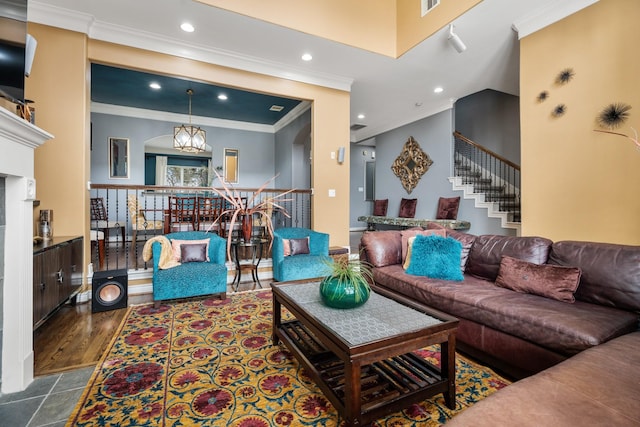 living room with tile patterned floors, ornamental molding, and a chandelier