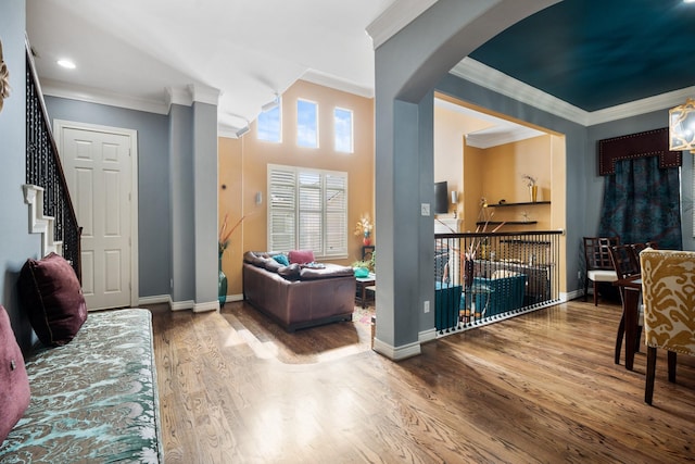 living room featuring hardwood / wood-style flooring and crown molding