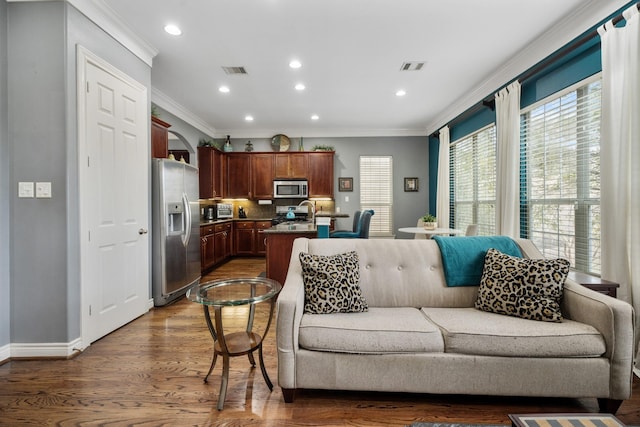 living room featuring crown molding and dark hardwood / wood-style floors