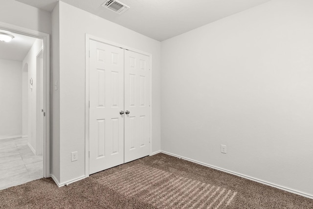 unfurnished bedroom featuring a closet and carpet