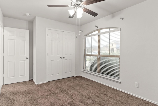 unfurnished bedroom with carpet flooring, ceiling fan, and a closet