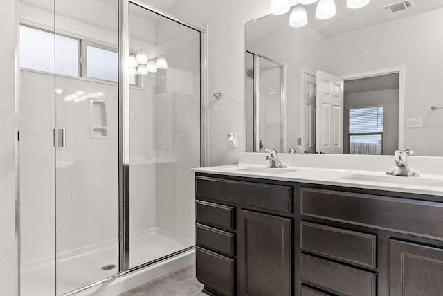 bathroom featuring vanity and an enclosed shower