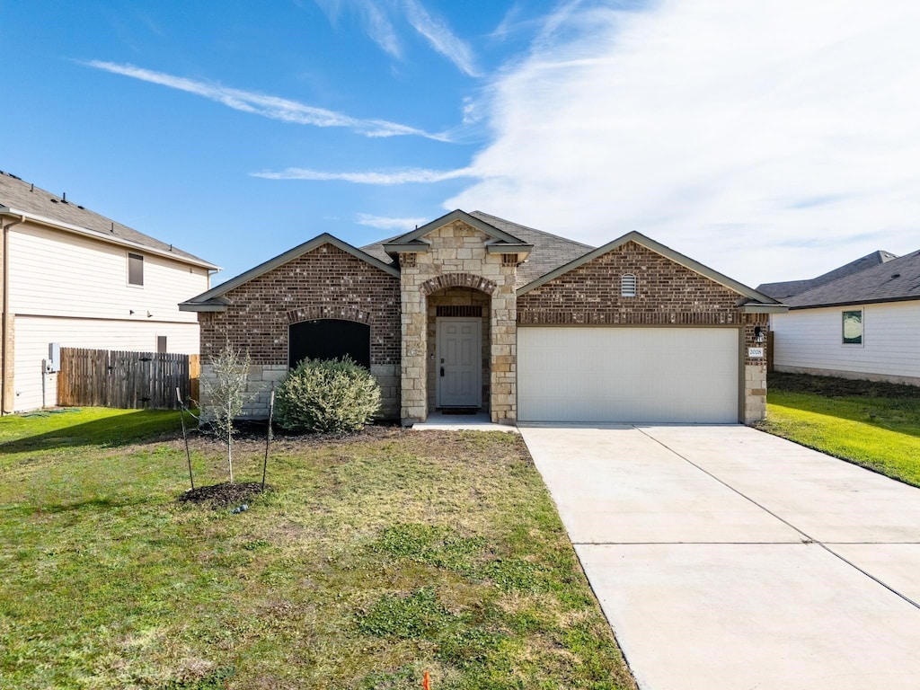 view of front of home featuring a garage and a front yard