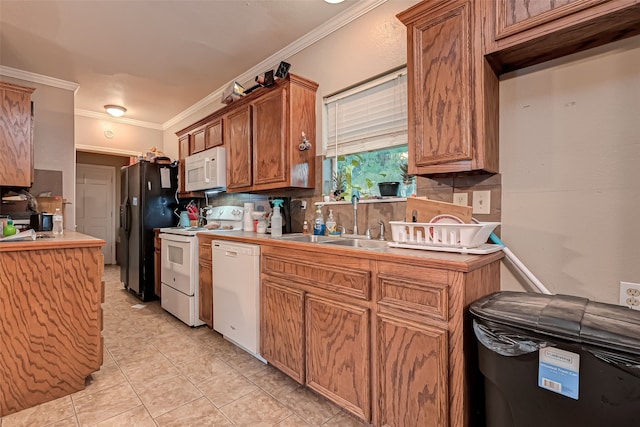 kitchen with sink, decorative backsplash, ornamental molding, light tile patterned floors, and white appliances