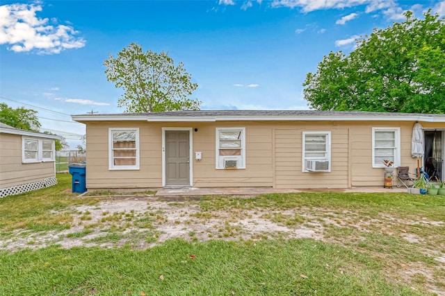 view of front of house featuring a front yard and cooling unit