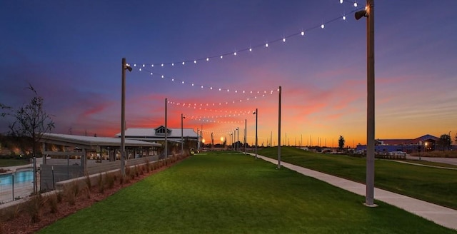 view of property's community featuring a yard and a pergola