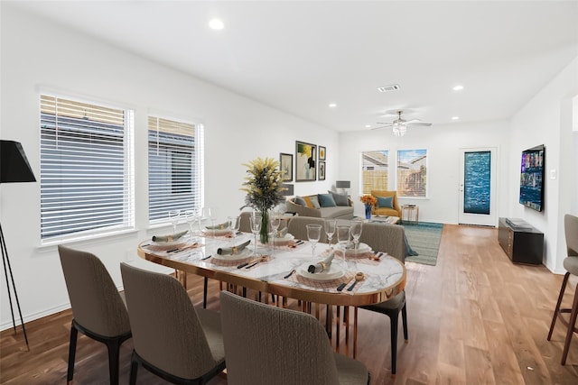 dining room with ceiling fan, a healthy amount of sunlight, and light hardwood / wood-style floors