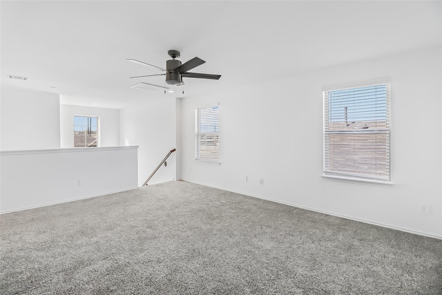 carpeted spare room featuring ceiling fan