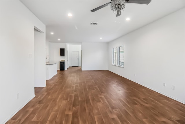 spare room with dark hardwood / wood-style flooring, sink, and ceiling fan