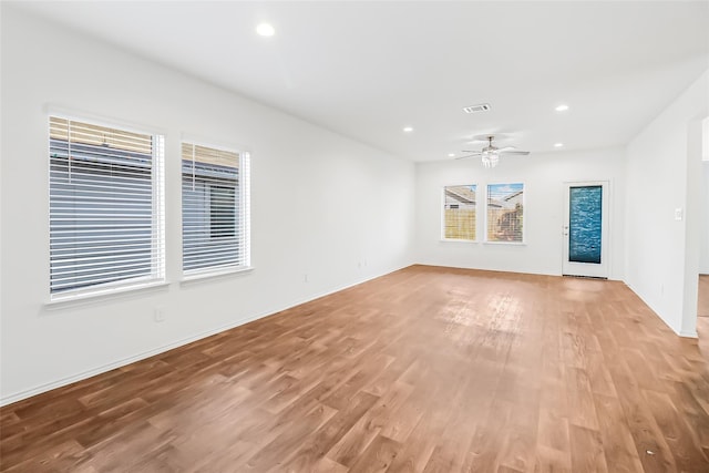 unfurnished living room with ceiling fan and light wood-type flooring