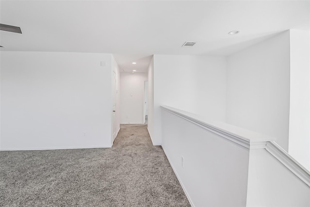 hallway with light colored carpet