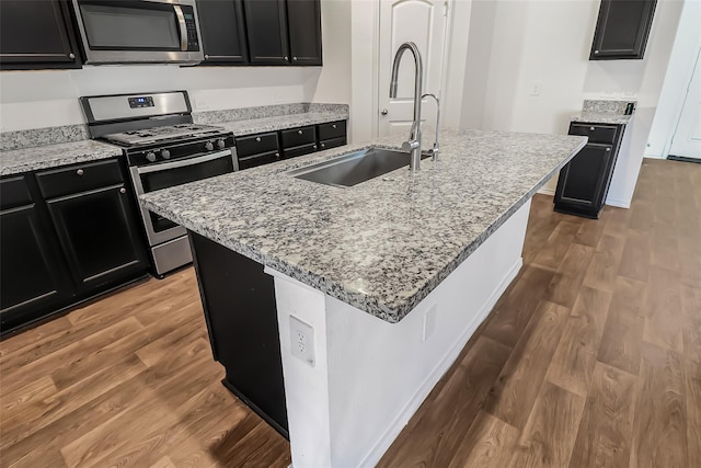 kitchen featuring sink, a center island with sink, and appliances with stainless steel finishes