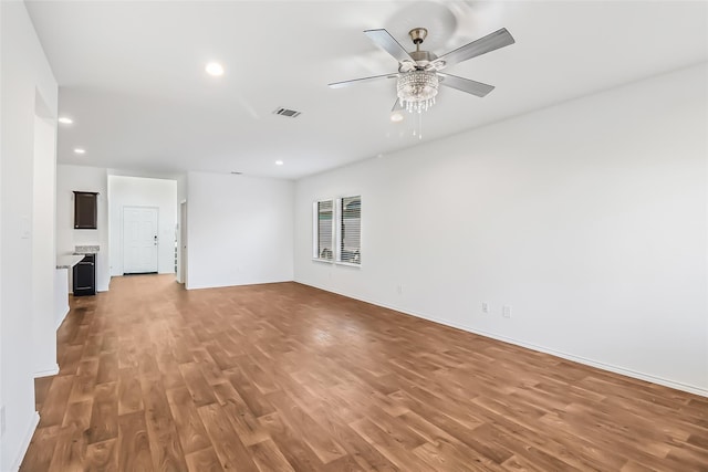 unfurnished living room featuring hardwood / wood-style flooring and ceiling fan