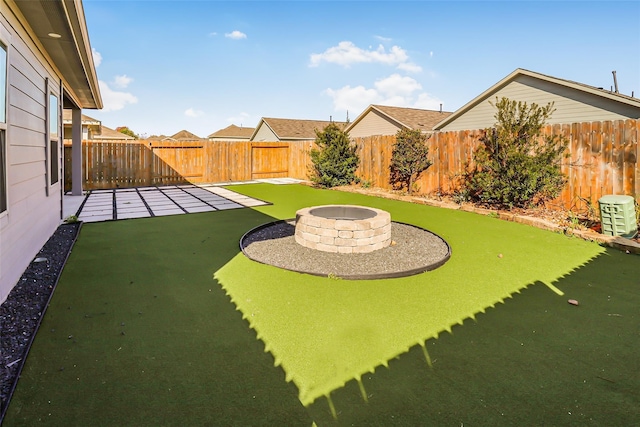 view of yard with a fire pit and a patio