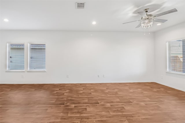 unfurnished room with hardwood / wood-style flooring and ceiling fan