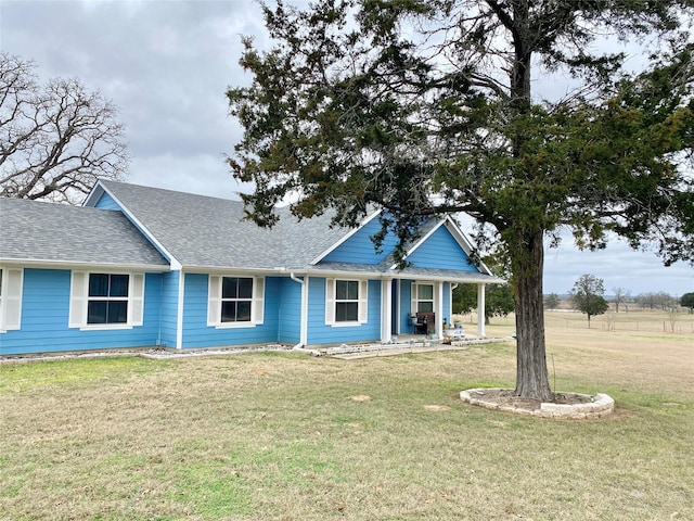 view of front of house with a front yard and covered porch