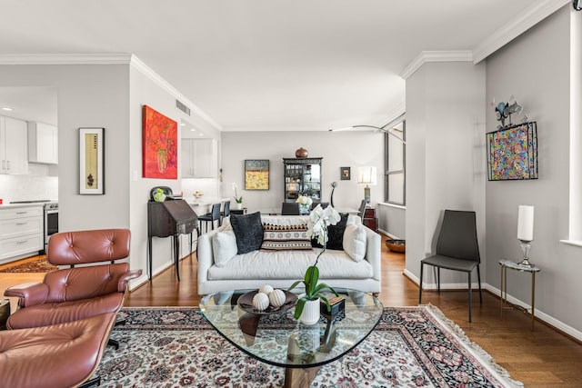 living area with visible vents, baseboards, dark wood-type flooring, and crown molding