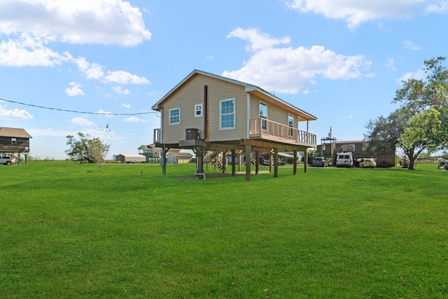 back of house featuring a yard and a deck