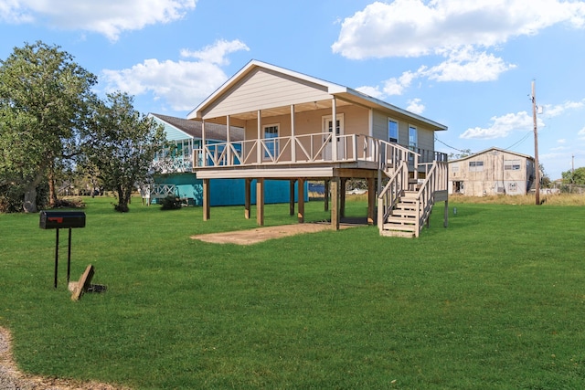 back of property featuring a wooden deck and a yard