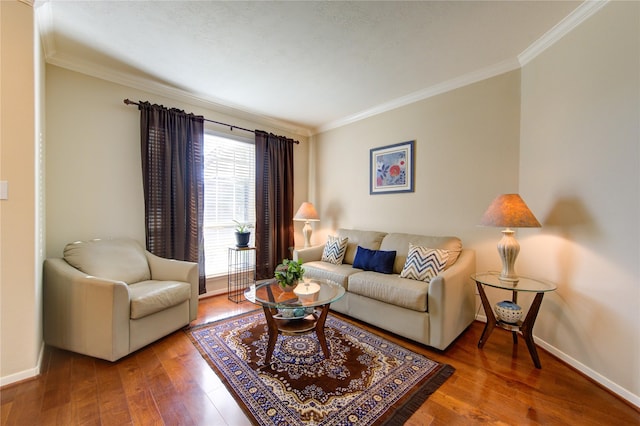 living area with crown molding, baseboards, and wood finished floors