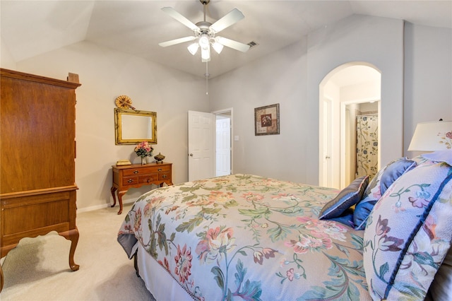 bedroom with arched walkways, lofted ceiling, visible vents, light carpet, and ceiling fan