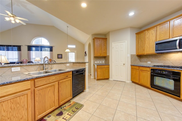 kitchen with light tile patterned floors, a sink, hanging light fixtures, light stone countertops, and black appliances