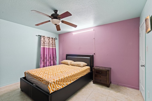 bedroom featuring ceiling fan, a textured ceiling, and light tile patterned floors