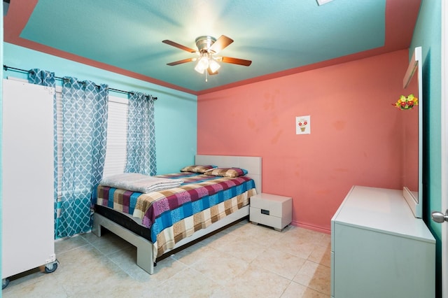 tiled bedroom featuring ceiling fan