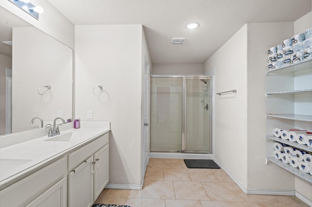 bathroom with vanity, tile patterned floors, and walk in shower
