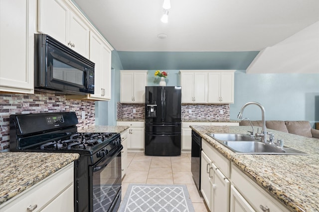 kitchen with light tile patterned flooring, sink, white cabinets, backsplash, and black appliances