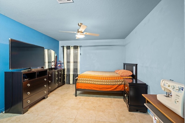 bedroom with light tile patterned floors, a textured ceiling, and ceiling fan