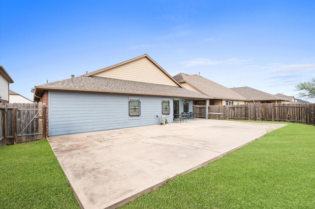 back of property with a yard and a patio