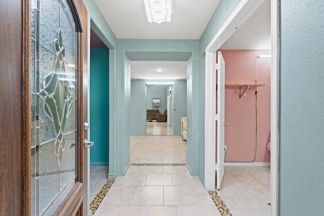 corridor with light tile patterned flooring