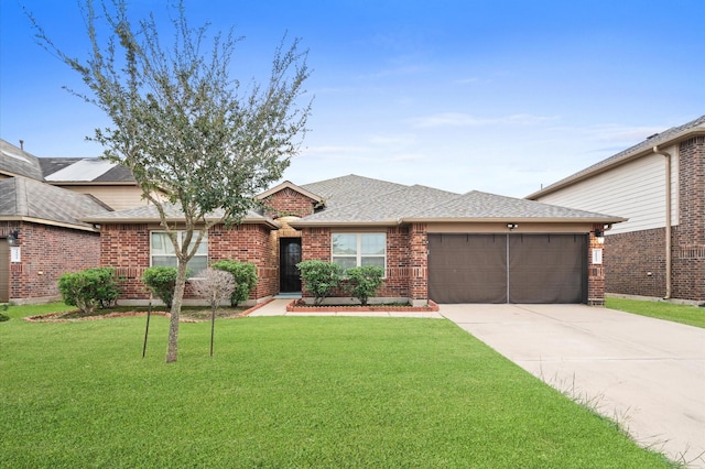 view of front of property featuring a garage and a front yard