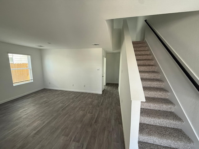 stairs with hardwood / wood-style floors