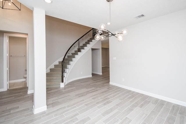 interior space with a chandelier and light wood-type flooring