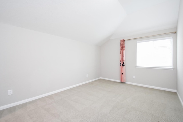 bonus room featuring light carpet and vaulted ceiling