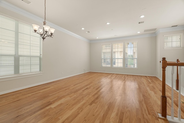 unfurnished room featuring light wood finished floors, baseboards, visible vents, crown molding, and a notable chandelier