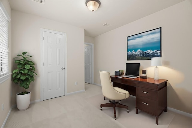 office with light colored carpet, visible vents, and baseboards