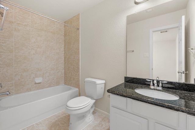 bathroom featuring toilet, vanity, baseboards, bathing tub / shower combination, and tile patterned floors